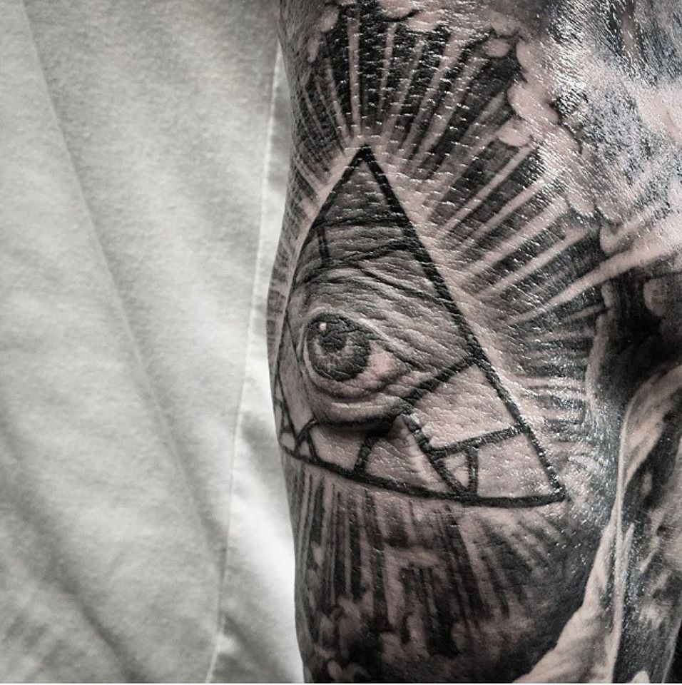 Red and Blue Eyes on Elbow Tattoo Idea
